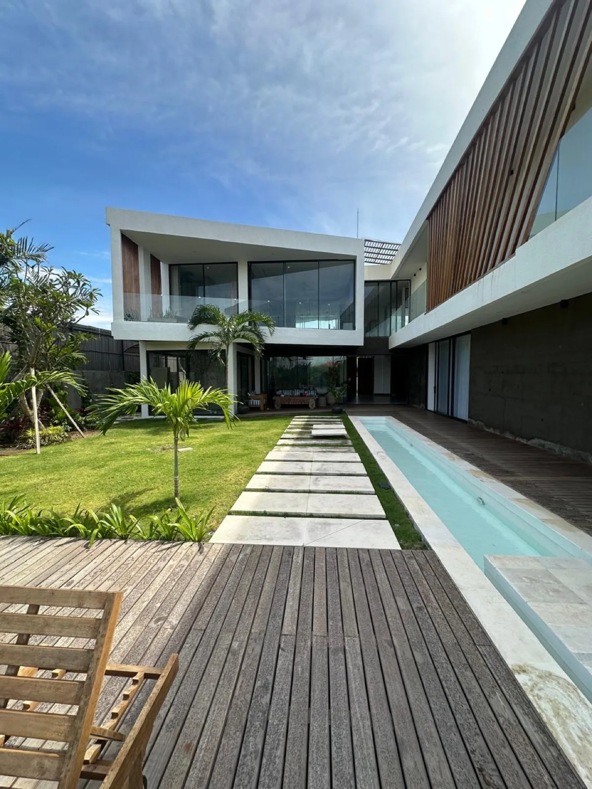 Modern villa facade with garden and pool