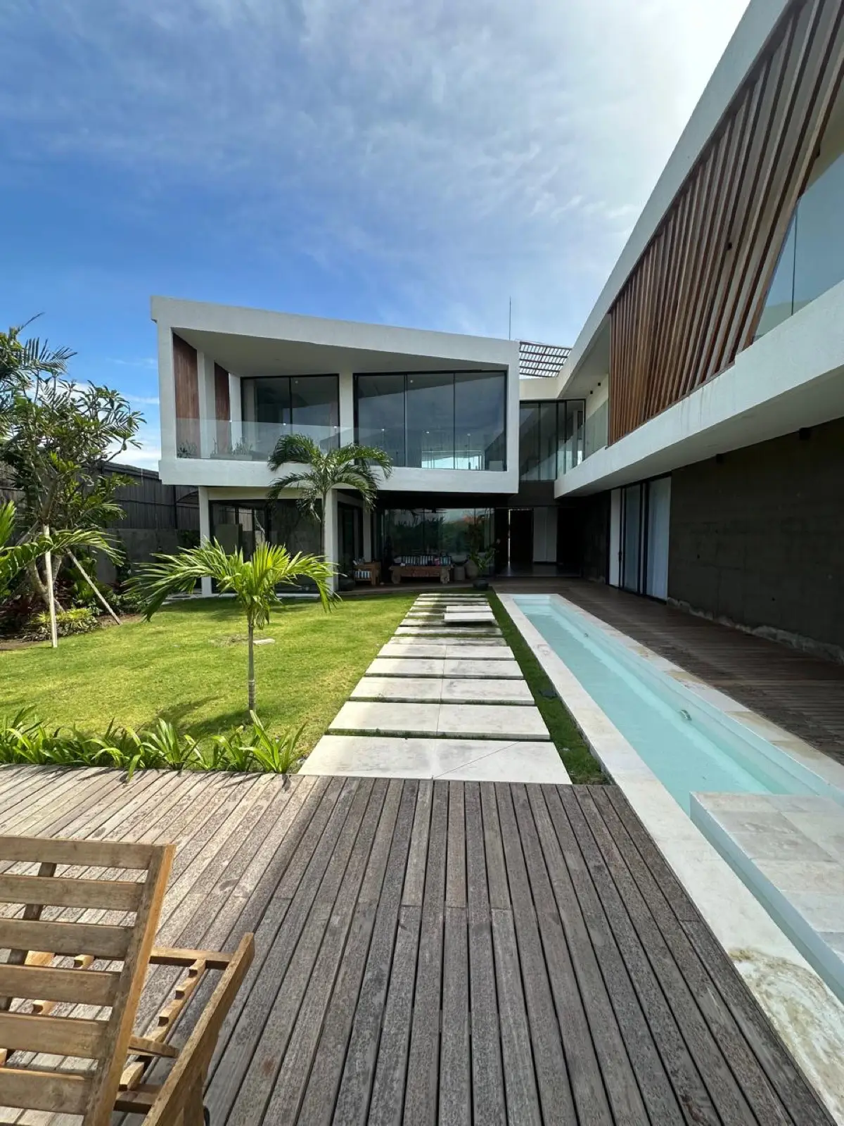 Modern villa facade with garden and pool