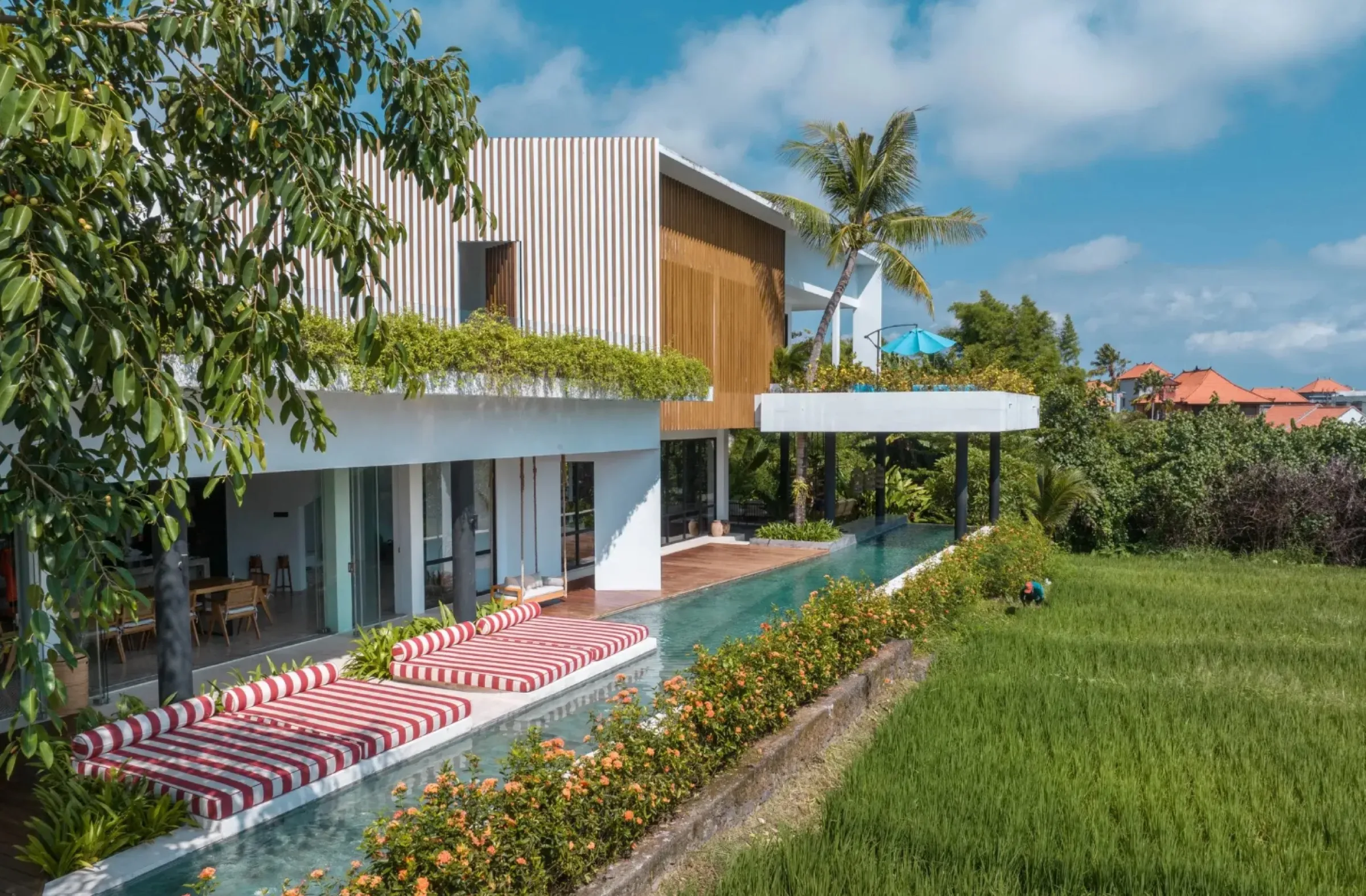 Mandala the Oasis villa with a long swimming pool bordering rice fields in Tibubeneng, Badung Regency — a Jiwa Karya Konsultan SLF project